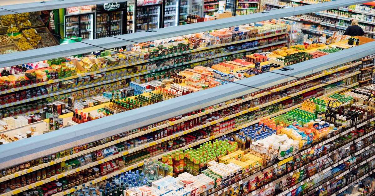 Explore the colorful, fully-stocked shelves of a bustling supermarket from above.