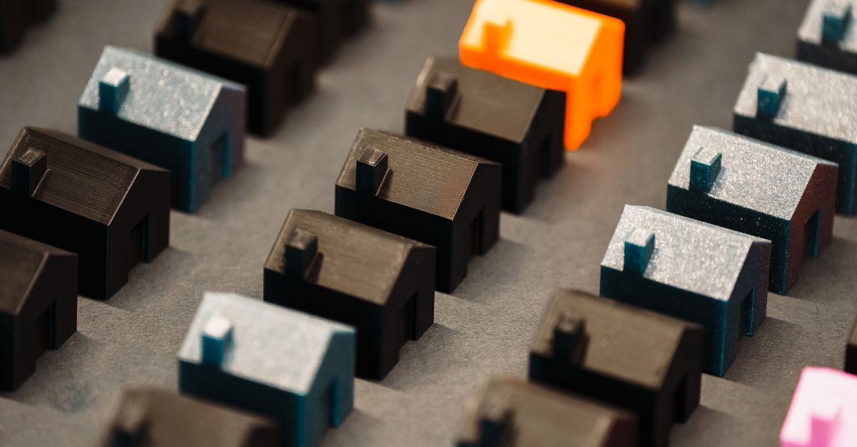 Close-up of colorful 3D model houses showcasing real estate concepts with a vibrant standout piece.