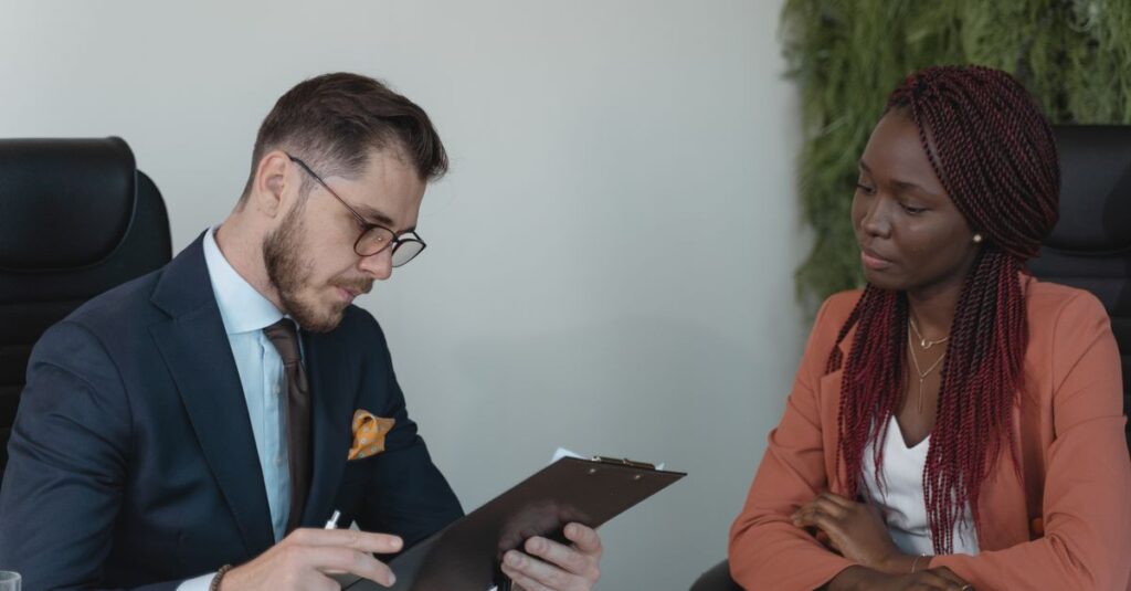 A man and woman engaging in a job interview in a modern office setting.