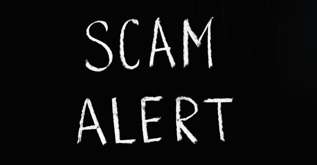 Blackboard with 'Scam Alert' written in white chalk, emphasizing a warning concept.