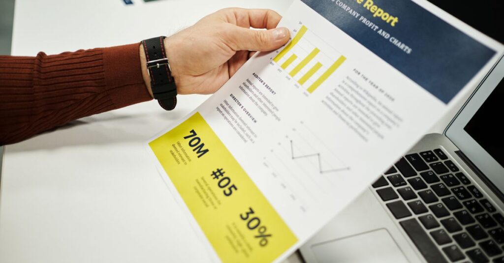 Person analyzing finance report with graphs at desk, ideal for business concepts.