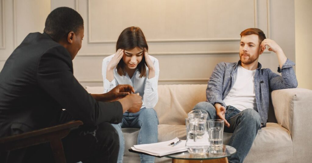 A couple attending a counseling session with a therapist, discussing their issues.