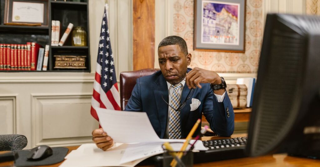 A focused lawyer reading documents in an office, symbolizing professionalism and legal expertise.