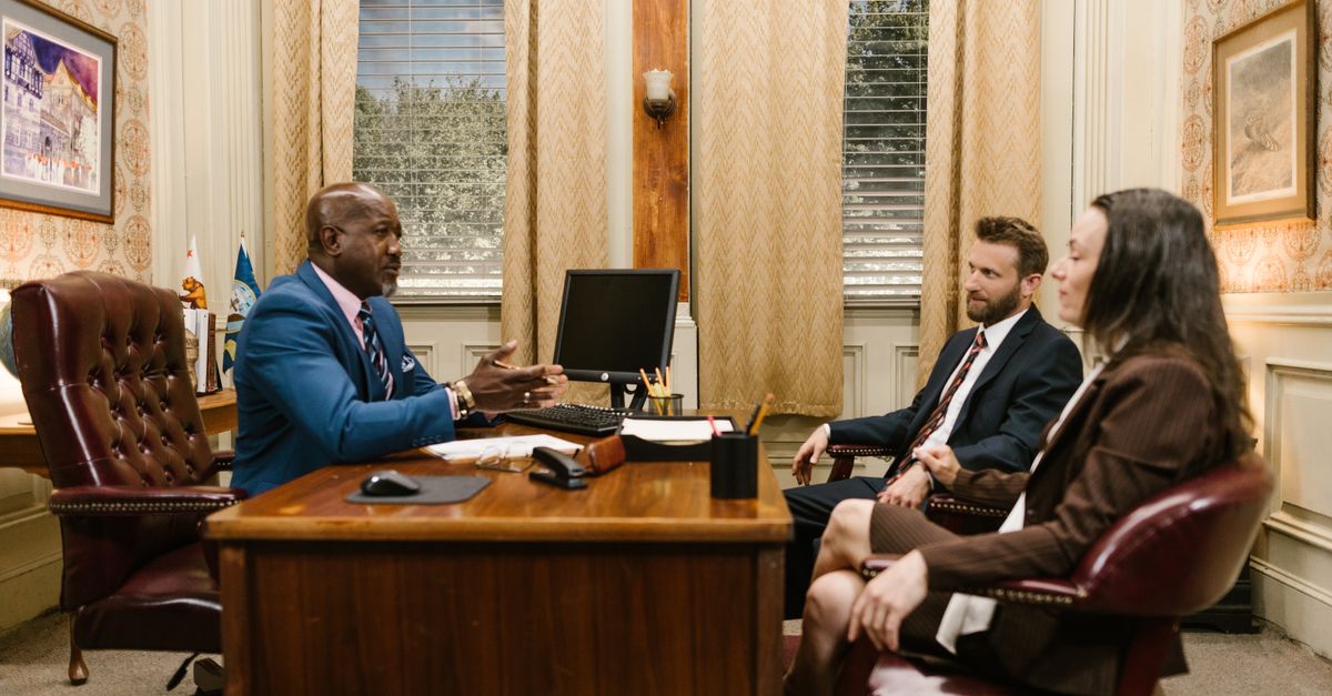 Lawyers discussing with a client in a professional office environment. Business meeting concept.