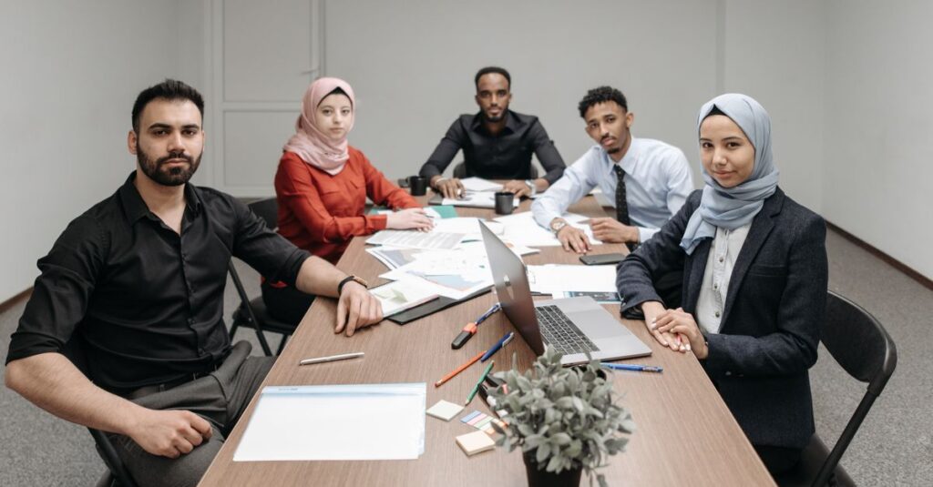 A diverse group of professionals engaging in a business meeting in a modern office setting.