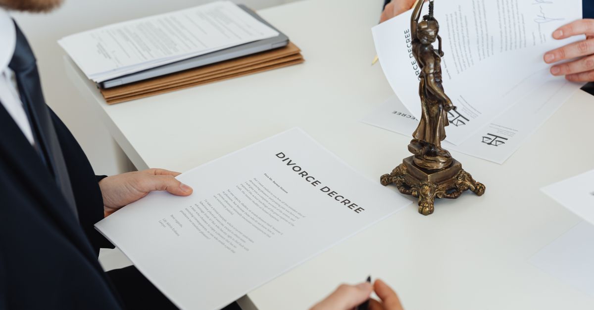 Two professionals discuss divorce decree documents, focusing on legal negotiations.