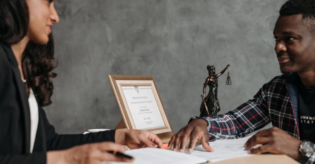 Two professionals engaged in a discussion over legal documents in an office setting.