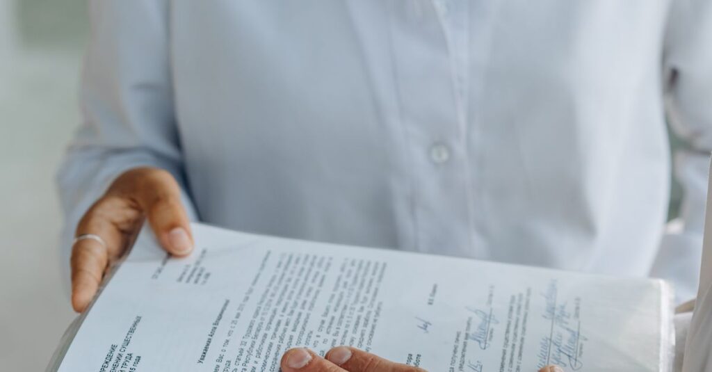 Close-up of hands analyzing a legal document in an office setting.