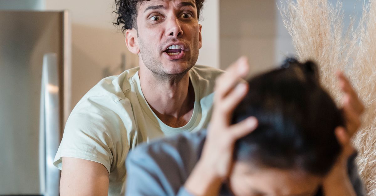 A man and woman in a tense emotional confrontation in a kitchen setting.