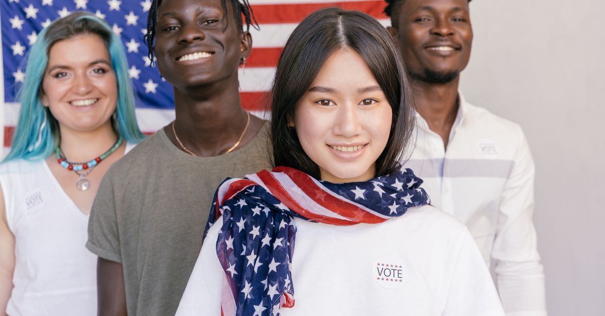 Four diverse individuals with flag, promoting unity and democracy in America.