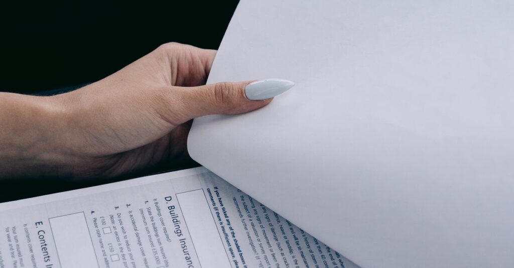 Detailed view of a person holding documents and a pen, ideal for business content.