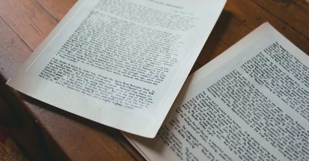 Close-up of open book pages on a wooden table with an inkwell, creating a vintage feel.