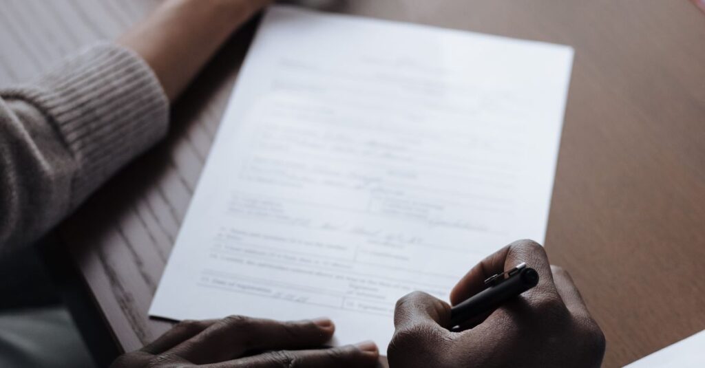 Intimate scene of a couple signing important adoption documents at home, highlighting diversity and parenting.